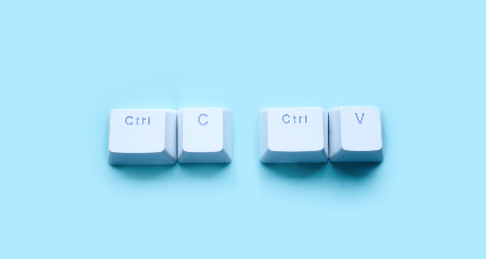 Close-up image of computer keyboard keys: Ctrl, C, and V, representing copy and paste functions.